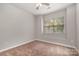 Bright bedroom with neutral carpet, ceiling fan and large window with blinds at 5645 Kimmerly Woods Dr # 2206, Charlotte, NC 28215