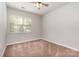 Well-lit bedroom with neutral carpet and a ceiling fan at 5645 Kimmerly Woods Dr # 2206, Charlotte, NC 28215