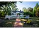 Charming white cottage with red door, picket fence, and brick pathway at 292 Mocksville Hwy, Statesville, NC 28625