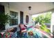 Relaxing front porch featuring wicker chairs, a swing, and potted plants at 292 Mocksville Hwy, Statesville, NC 28625