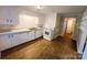 Kitchen with white cabinets and view into hallway at 104 1/2 Tomberlin Rd, Mount Holly, NC 28120