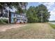 Blue house with a red brick foundation, set back from the road at 12137 Renee Ford Rd, Stanfield, NC 28163