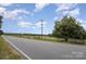 Road view of property with open fields and trees at 12137 Renee Ford Rd, Stanfield, NC 28163