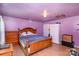 Main bedroom with wood bed frame and light purple walls at 12137 Renee Ford Rd, Stanfield, NC 28163