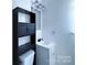 Simple bathroom with a pedestal sink and storage cabinet at 5115 Rosemede Dr, Charlotte, NC 28227