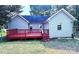 Home's backyard features a spacious red deck at 5115 Rosemede Dr, Charlotte, NC 28227