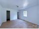 Bright bedroom with tile floors and a spacious closet at 5115 Rosemede Dr, Charlotte, NC 28227