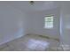 Simple bedroom with tile floors and a window at 5115 Rosemede Dr, Charlotte, NC 28227