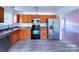 Kitchen with wood cabinets, stainless steel appliances, and vinyl flooring at 5115 Rosemede Dr, Charlotte, NC 28227
