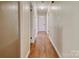 Long hallway with light wood flooring and access to bedrooms at 1535 Maplewood Ave, Lancaster, SC 29720