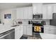 White kitchen cabinets and stainless steel appliances at 912 Broad River Ln, Charlotte, NC 28211