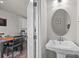 Small powder room with pedestal sink and oval mirror at 912 Broad River Ln, Charlotte, NC 28211