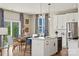 Modern kitchen with white cabinets, island, and stainless steel appliances at 15010 Caspian Way, Charlotte, NC 28278