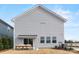 Rear view of house showcasing patio and landscaping at 15010 Caspian Way, Charlotte, NC 28278