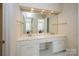 Double vanity bathroom with a large mirror and tiled floors at 5066 Ashford Crest Ln, Charlotte, NC 28226