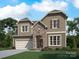 Two story home with stone accents and landscaping at 2009 Clapham Ct # Ken0098, Charlotte, NC 28215