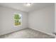 Simple bedroom with neutral wall and carpet, featuring a window at 472 Picadilly Ln, Troutman, NC 28166