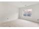 Unfinished bedroom with a large window, white walls, and light-colored flooring at 6201 Bud Huey Rd, Waxhaw, NC 28173