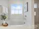 Relaxing bathroom featuring a free-standing tub and large window at 1038 Heath Helms Rd, Monroe, NC 28110