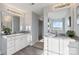 Double vanity bathroom with granite countertops and a large mirror at 1038 Heath Helms Rd, Monroe, NC 28110