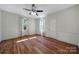 Hardwood floor bedroom with ceiling fan and large windows at 109 N York St, Lancaster, SC 29720