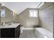 Clean bathroom with tub, shower, and dark vanity at 109 N York St, Lancaster, SC 29720