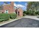 Brick home showcasing a side view and additional parking area at 109 N York St, Lancaster, SC 29720