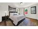 Comfortable bedroom with hardwood floors, large bed, and neutral decor at 109 N York St, Lancaster, SC 29720