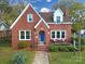 Red brick house with a blue front door and well-manicured lawn at 109 N York St, Lancaster, SC 29720