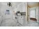 Kitchen with white cabinets, marble flooring, and modern appliances at 109 N York St, Lancaster, SC 29720