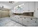 White kitchen with marble-look flooring and updated countertops at 109 N York St, Lancaster, SC 29720