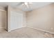 Spacious bedroom with ceiling fan and large window at 13733 Singleleaf Ln, Charlotte, NC 28279