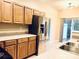 Kitchen features stainless steel refrigerator and light wood cabinets at 13733 Singleleaf Ln, Charlotte, NC 28279