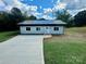 Newly built light gray house with dark gray metal roof and a long driveway at 901 Linney Ln, Shelby, NC 28152