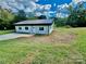 Newly constructed single-story home with a metal roof and grassy yard at 901 Linney Ln, Shelby, NC 28152
