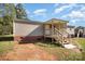 Tan mobile home with covered porch and stairs at 1036 Lakeland Ave, Lincolnton, NC 28092