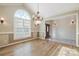 Bright dining room with hardwood floors and chandelier at 2488 Birdie Ne Ln, Conover, NC 28613
