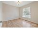 Simple bedroom with hardwood floors and a large window at 2488 Birdie Ne Ln, Conover, NC 28613