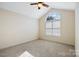 Bright bedroom with arched window and ceiling fan at 2488 Birdie Ne Ln, Conover, NC 28613