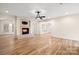 Bright living room with hardwood floors, a fireplace, and access to other rooms at 2488 Birdie Ne Ln, Conover, NC 28613