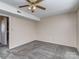 Bright bedroom with ceiling fan and grey carpet flooring at 11014 Cedar View Rd, Charlotte, NC 28226