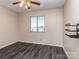 Bedroom with ceiling fan, window, and wood-look flooring at 11014 Cedar View Rd, Charlotte, NC 28226