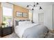 Spacious primary bedroom with wood-paneled accent wall and neutral decor at 417 Blairhill Rd # 12, Charlotte, NC 28217