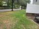 Side yard with patchy grass and a portion of a fence at 7308 Gallery Pointe Ln, Charlotte, NC 28269
