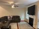 Spacious living room with a large TV, fireplace, and comfortable sectional sofa at 7308 Gallery Pointe Ln, Charlotte, NC 28269