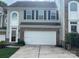 Two-story townhome with a white garage door at 7308 Gallery Pointe Ln, Charlotte, NC 28269