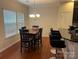 Bright dining room featuring a table with four chairs and access to the kitchen at 7308 Gallery Pointe Ln, Charlotte, NC 28269