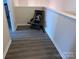 Upstairs hallway with light gray flooring and a wooden chair at 7308 Gallery Pointe Ln, Charlotte, NC 28269