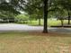 View of quiet tree-lined neighborhood street at 7308 Gallery Pointe Ln, Charlotte, NC 28269