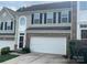 Two-story townhome with a white garage door at 7308 Gallery Pointe Ln, Charlotte, NC 28269